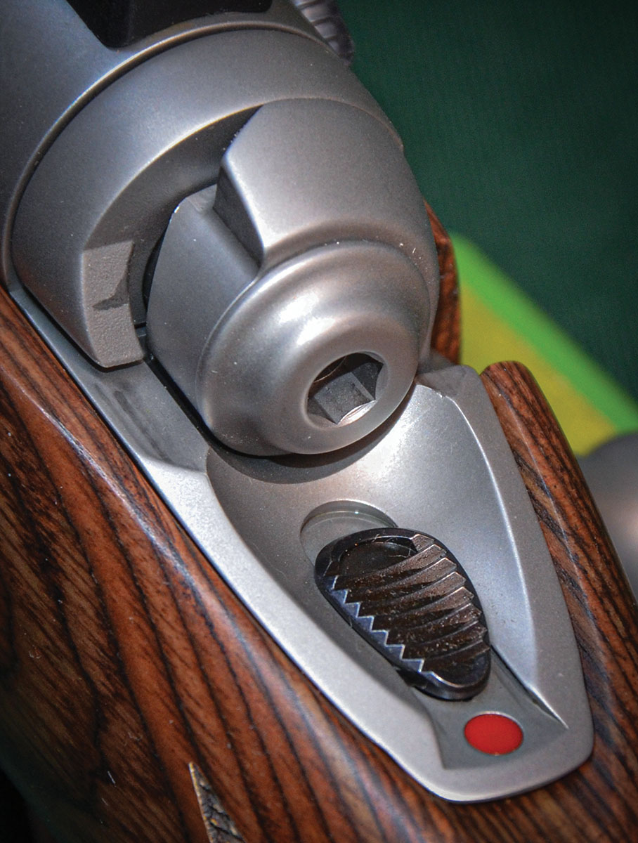 The safety slide of the Model 110 action is a 3-position design. Pushing the slide all the way to the rear blocks trigger travel and bolt rotation. Pushing it to the middle position allows the bolt to be rotated for loading or unloading the chamber with the trigger still blocked from movement. Pushing it all the way forward (shown here) readies the rifle.